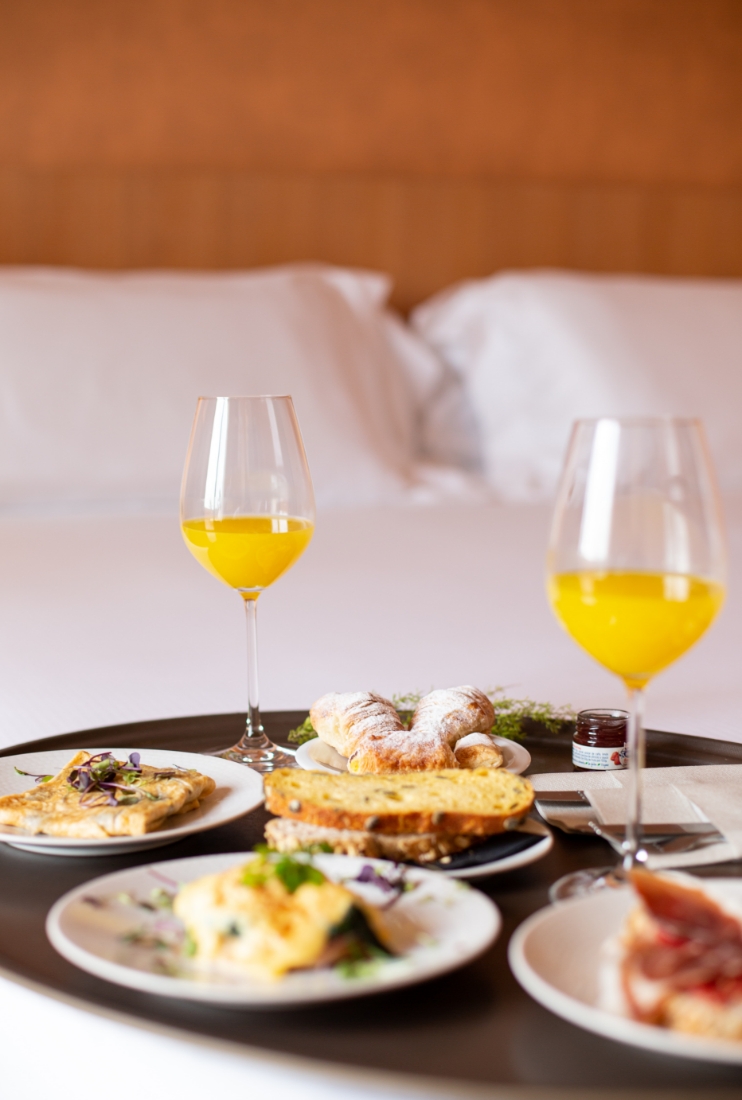 Image of breakfast served in room on bed.
